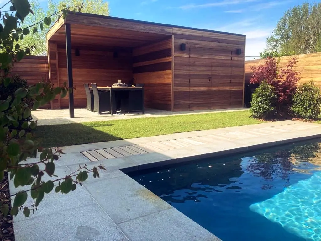 Houten poolhouse met overdekte zithoek naast het zwembad en een houten schutting — Oase-tuin, Ternat